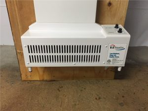 EZ Breathe ventilation system mounted on a wooden surface, designed for improving indoor air quality in basements and crawlspaces.